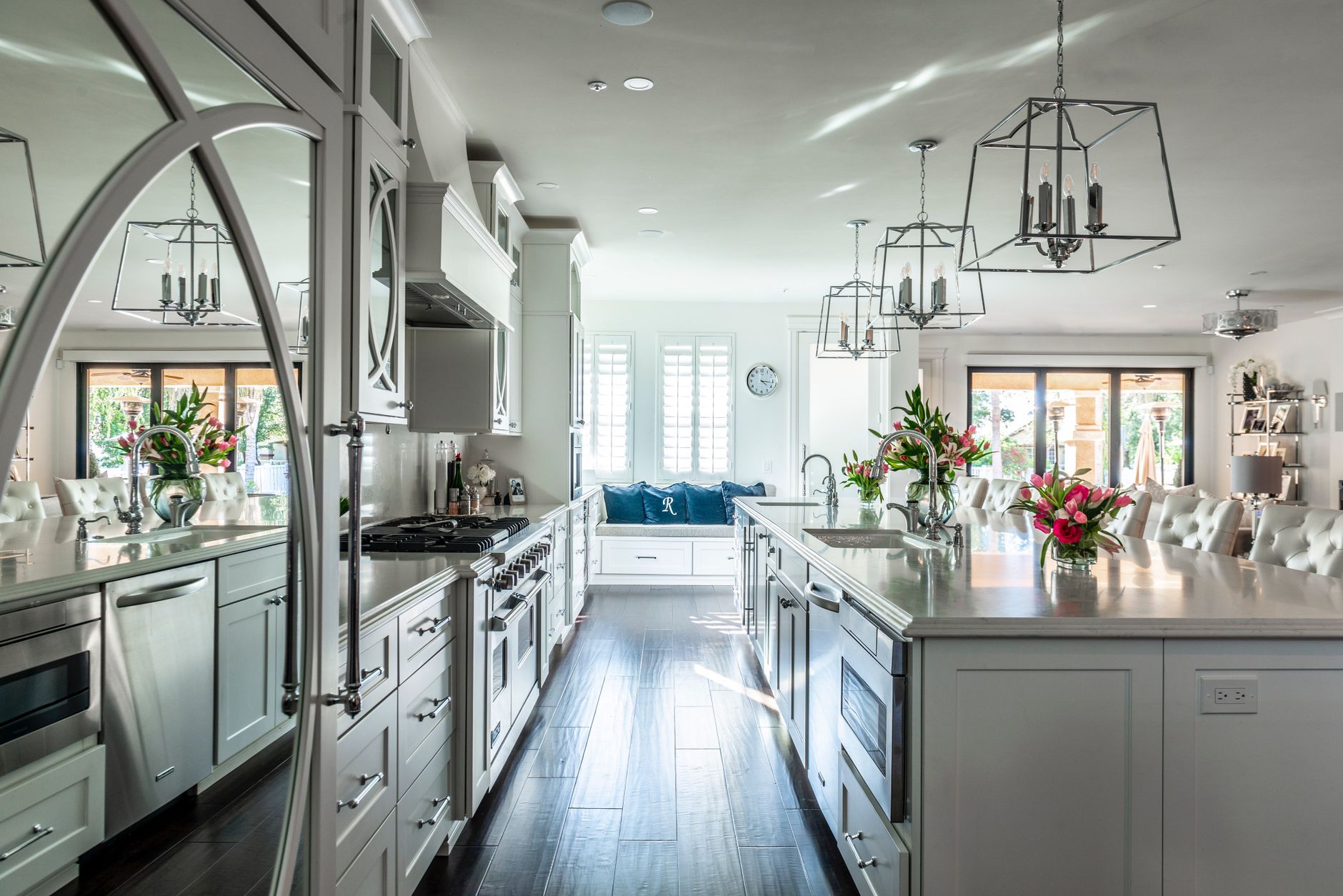 Elegant modern kitchen featuring an island, white cabinetry, and stainless steel appliances in Carlsbad, CA
