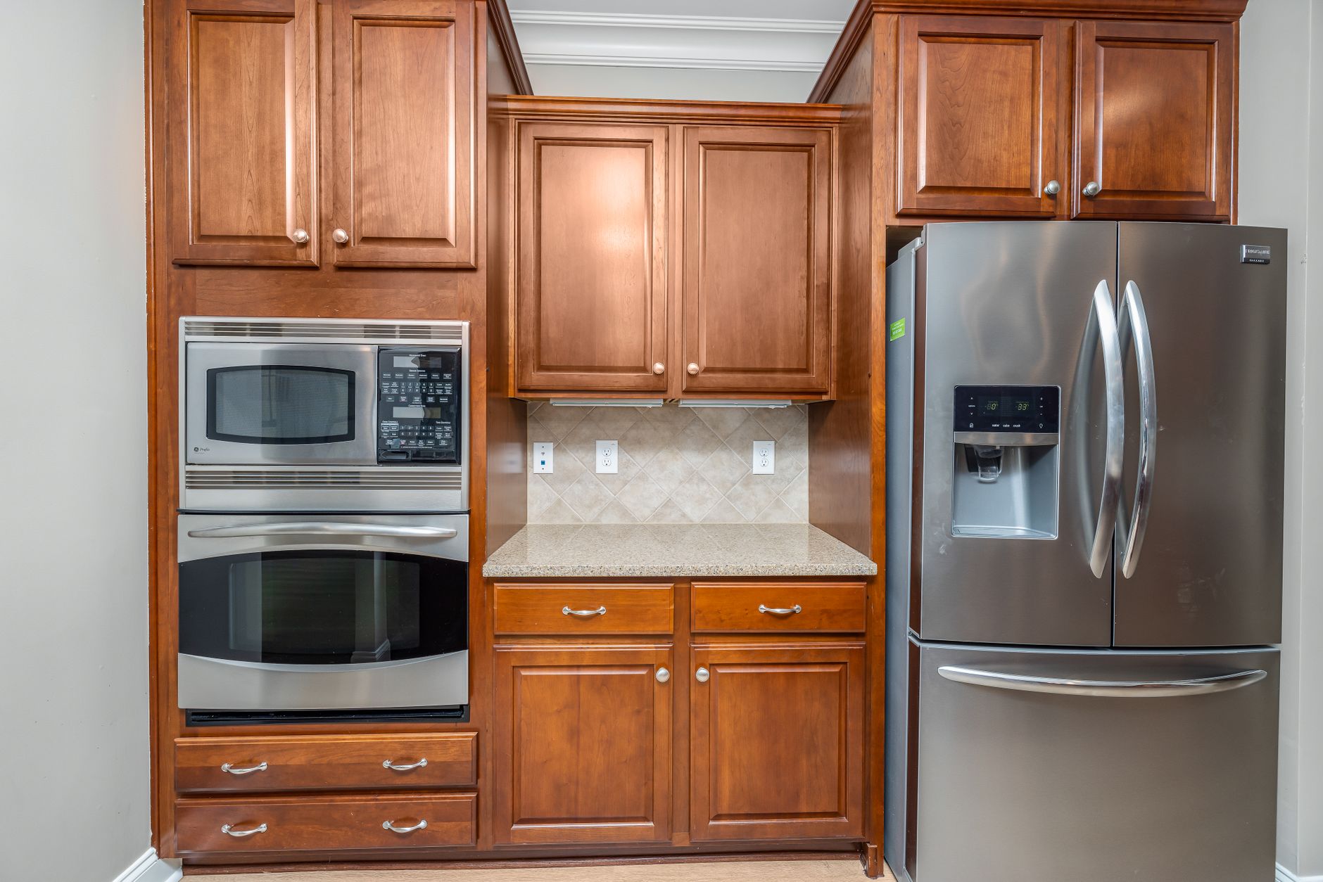 Elegant kitchen featuring stainless steel appliances and wooden cabinets in Carlsbad, CA